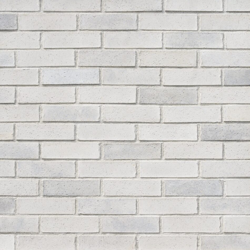 Wall of white and gray brick veneer.