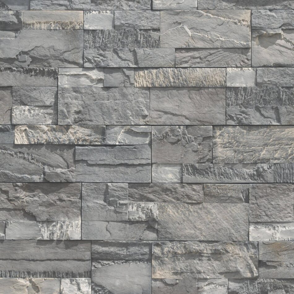 A pre-assembled stone veneer wall in the shade Shadowplay with pronounced sawtooth texture and stones in varying shapes and sizes.