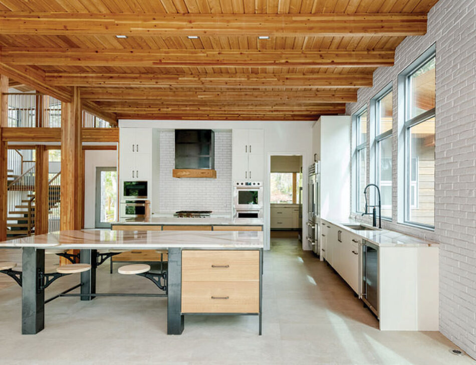 Kitchen interior showing accent wall and stove backsplash made up of white brick veneer.