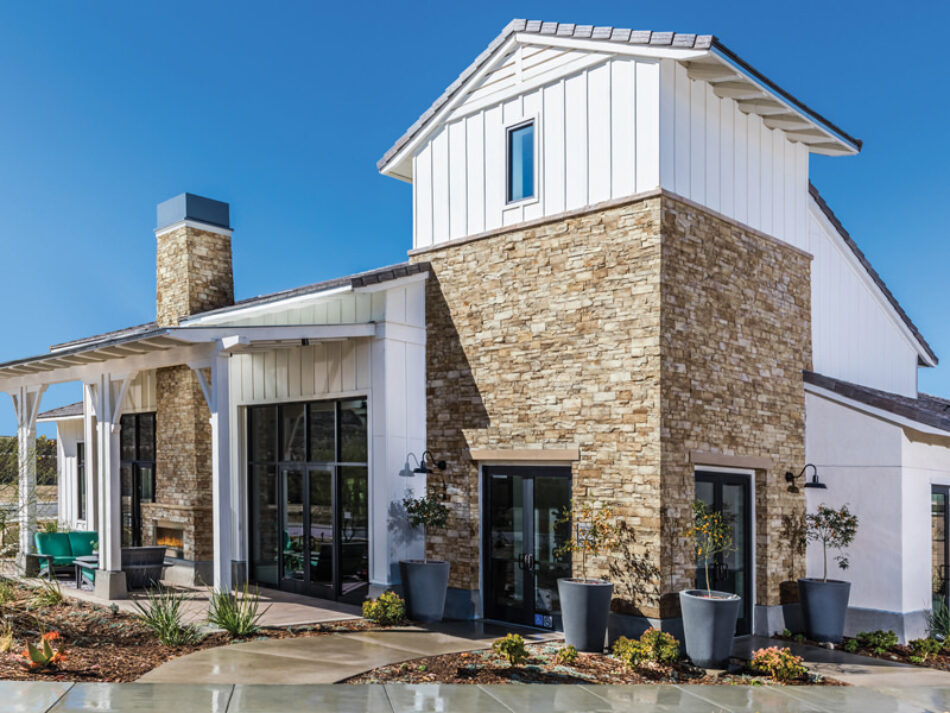 This building has a farmhouse feel with white board and batten siding, black industrial oversized windows and stone veneer. There is a beautiful patio in the backyard with a fireplace.